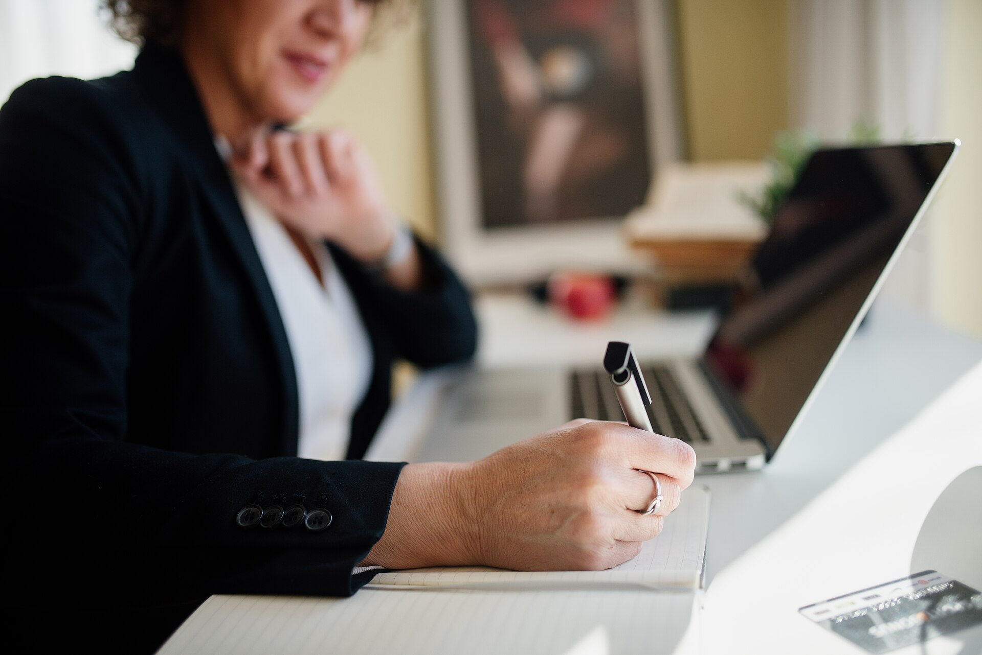 Profesional tomando notas durante una reunión de consultoría